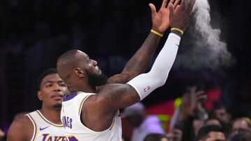 Dec 15, 2024; Los Angeles, California, USA; Los Angeles Lakers forward LeBron James (23) throws powdered chalk into the air during the game against the Memphis Grizzlies at Crypto.com Arena. Mandatory Credit: Kirby Lee-Imagn Images