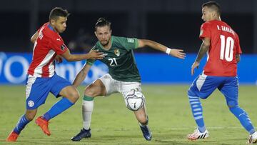 Bolivia&#039;s Oscar Rivera, center, battles for the ball with Paraguay&#039;s Angel Romero, left, and Alejandro Romero during a qualifying soccer match for the FIFA World Cup Qatar 2022, at the Defensores del Chaco stadium in Asuncion, Paraguay, Tuesday, Nov. 17, 2020. (AP Photo/Jorge Saenz)