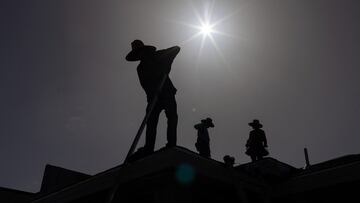 Roofers sport hats to take cover from the sun during a heatwave in Eagle Pass, Texas, U.S. July 27, 2023. REUTERS/Adrees Latif TPX IMAGES OF THE DAY