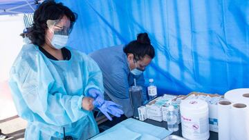A health worker prepares a vaccine during the Saban Community Clinic Vaccine Drive Up for LA Children first day event, August 12, 2020, in Los Angeles, California. - Vaccines are still required to enroll for school. Every family, including those without health insurance insurance, can get their school-vaccinations at the Saban Community Clinic drive up. (Photo by VALERIE MACON / AFP)