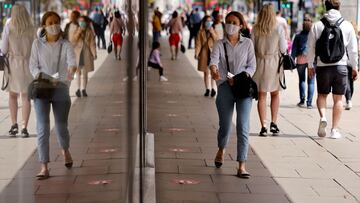 Pedestrians wearing a face mask or covering due to the COVID-19 pandemic, walk along Oxford Street in central London on June 6, 2020. - The Delta variant of the coronavirus, first discovered in India, is estimated to be 40 percent more transmissible than the Alpha variant that caused the last wave of infections in the UK, Britain's health minister said Sunday. (Photo by Tolga Akmen / AFP)