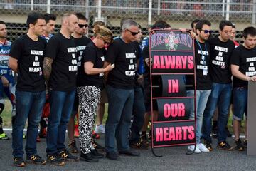 Relatives and mechanics of SAG Team Moto2 Spanish rider Luis Salom observe a minute of silence during a tribute for the 24-year-old.