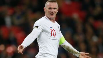 England's striker Wayne Rooney gestures to United States' goalkeeper Brad Guzan after the final whistle during the international friendly football match between England and the United States at Wembley stadium in north London on November 15, 201