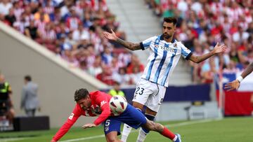 Atletico Madrid's Argentinian midfielder #05 Rodrigo De Paul falls next to Real Sociedad's Spanish midfielder #23 Brais Mendez during the Spanish league football match between Club Atletico de Madrid and Real Sociedad at the Wanda Metropolitano stadium in Madrid on October 8, 2023. (Photo by Pierre-Philippe MARCOU / AFP)