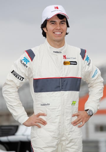 Sauber F1 team rookie driver Sergio Perez of Mexico poses for photographers during the presentation of the Sauber 2011 Formula one team at the Ricardo Tormo racetrack in Cheste, near Valencia, January 31, 2011. REUTERS/Heino Kalis (SPAIN - Tags: SPORT MOTOR RACING)