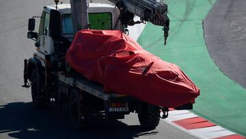 A truck carries the Ferrari of German driver Sebastian Vettel after he crashed into the barriers during the tests for the new Formula One Grand Prix season at the Circuit de Catalunya in Montmelo in the outskirts of Barcelona on February 27, 2019. (Photo by LLUIS GENE / AFP)