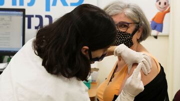 A woman receives her third dose of a coronavirus disease (COVID-19) vaccine at a Clalit healthcare maintenance organisation in Jerusalem August 1, 2021. REUTERS/Ronen Zvulun