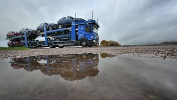 A truck driver carries Peugeot cars from a temporary parking in Malbouhans, eastern France on November 25, 2022. - Due to a lack of truck drivers, the Stellantis plant of Sochaux is not able to export all its cars and has to stock them on the Lure-Malbouhans desaffected airport, about 40 km from the industrial site. (Photo by SEBASTIEN BOZON / AFP) (Photo by SEBASTIEN BOZON/AFP via Getty Images)