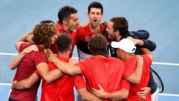 Novak Djokovic of Serbia (C) celebrates with teammates after winning his men's singles match against Daniil Medvedev of Russia at the ATP Cup tennis tournament in Sydney on January 11, 2020. (Photo by William WEST / AFP) / --IMAGE RESTRICTED TO EDITORIAL USE - NO COMMERCIAL USE--