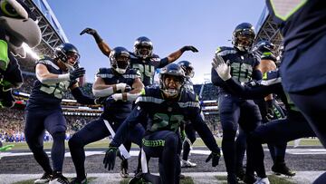 SEATTLE, WASHINGTON - JANUARY 08: The Seattle Seahawks celebrate an interception by Quandre Diggs #6 against the Los Angeles Rams during overtime at Lumen Field on January 08, 2023 in Seattle, Washington.   Steph Chambers/Getty Images/AFP (Photo by Steph Chambers / GETTY IMAGES NORTH AMERICA / Getty Images via AFP)