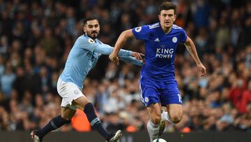 Leicester City's English defender Harry Maguire (R) goes past Manchester City's German midfielder Ilkay Gundogan (L) during the English Premier League football match between Manchester City and Leicester City at the Etihad Stadium in Manchester,