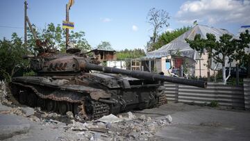 HOSTOMEL, UKRAINE - MAY 24: A children&#039;s cuddly toy sits on top of a destroyed Russian main battle tank, next to war damaged homes, on May 24, 2022 in Hostomel, Ukraine. As Russia concentrates its attack on the east and south of the country, resident