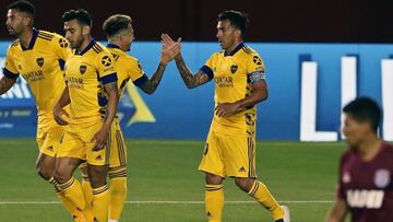 Argentina's Boca Juniors forward Carlos Tevez (R) celebrates with his teammate defender Julio Buffarini after scoring a goal against Lanus during an Argentina First Division 2020 football match at the Nestor Diaz Perez stadium, in Lanus, Buenos Aires province, Argentina, on October 31, 2020, amid the new coronavirus pandmeic. (Photo by ALEJANDRO PAGNI / POOL ARGRA / AFP)