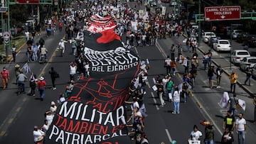 Demonstrators carry a banner during a march to mark the 54th anniversary of the 1968 Tlatelolco Square massacre, in which hundreds of students were shot dead by the military, in Mexico City, Mexico October 2, 2022. REUTERS/Luis Cortes