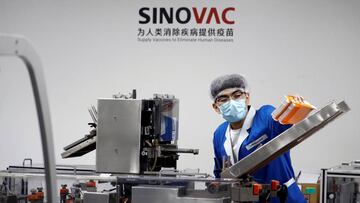 A man works in the packaging facility of Chinese vaccine maker Sinovac Biotech, developing an experimental coronavirus disease (COVID-19) vaccine, during a government-organized media tour in Beijing, China, September 24, 2020. REUTERS/Thomas Peter