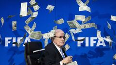 FIFA president Sepp Blatter looks on as fake dollar notes fly around him, thrown by a British comedian during a press conference at the FIFA world-body headquarter's in Zurich. -