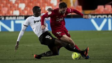 Mouctar Diakhaby of Valencia CF (L) in action against Jonathan Calleri Osasuna during Spanish La Liga match between Valencia cf and CA Osasuna at Mestalla stadium. In Valencia on January 21, 2021.