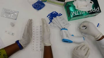 Medical technicians tests samples for COVID-19 anti-body tests at a temporary testing facility for frontline workers during a lockdown as a preventive measure against the COVID-19 coronavirus in Chennai on July 16, 2020. (Photo by Arun SANKAR / AFP)