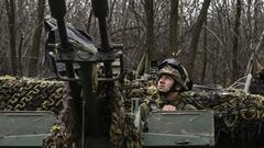 A Ukrainian serviceman looks on as he sits on an anti-air gun near Bakhmut, on March 24, 2023. (Photo by Aris Messinis / AFP) (Photo by ARIS MESSINIS/AFP via Getty Images)