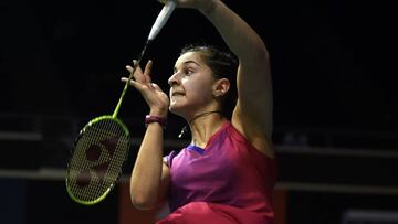 Carolina Marin of Spain returns a shot against Akane Yamaguchi of Japan during their women's singles quarter-final badminton match at the Singapore Open.