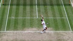 Serbia's Novak Djokovic serves from the baseline against Italy's Lorenzo Musetti during their men's singles semi-final tennis match on Centre Court on the twelfth day of the 2024 Wimbledon Championships at The All England Lawn Tennis and Croquet Club in Wimbledon, southwest London, on July 12, 2024. (Photo by HENRY NICHOLLS / AFP) / RESTRICTED TO EDITORIAL USE