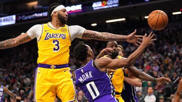 Dec 19, 2024; Sacramento, California, USA; Sacramento Kings guard Malik Monk (0) loses control of the ball next to Los Angeles Lakers forward Anthony Davis (3) in the third quarter at the Golden 1 Center. Mandatory Credit: Cary Edmondson-Imagn Images