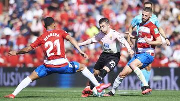 GRANADA, SPAIN - FEBRUARY 01: Adrian Embarba of RCD Espanyol duels for the ball with Yangel Herrera of Granada CF during the Liga match between Granada CF and RCD Espanyol at Nuevo Estadio de Los Carmenes on February 01, 2020 in Granada, Spain. (Photo by