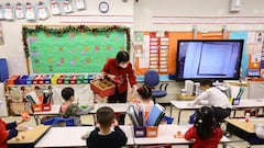 Principal Alice Hom hands out red envelopes and candy in a cultural celebration of the Lunar New Year.