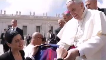 El Papa Francisco recibiendo una camiseta dedicada de Andr&eacute;s Iniesta de manos de Anna Vives, una dise&ntilde;adora con S&iacute;ndrome de Down y una de los &quot;siete talentos inesperados&quot; que forman parte de &quot;La empresa m&aacute;s loca del mundo&quot;.