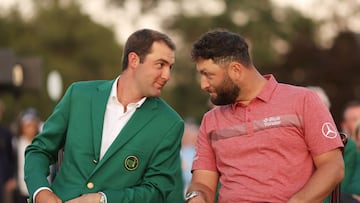 Masters Champion Scottie Scheffler of the United States looks on with Jon Rahm of Spain