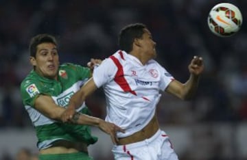 GRA294 SEVILLA 15/03/2015.- El delantero colombiano del Sevilla Carlos Arturo Bacca (d) y el defensa chileno del Elche Enzo Roco, durante el partido de la vigésima séptima jornada de Liga de Primera División, disputado esta tarde en el estadio Sánchez Pizjuán. EFE/Julio Muñoz
