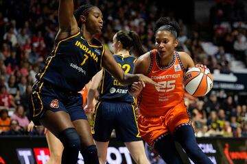 Alyssa Thomas #25 of the Connecticut Sun drives to the rim against Aliyah Boston #7 of the Indiana Fever 