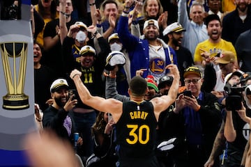 Curry celebrates after shooting a three point basket with under a minute left during the game against the Dallas Mavericks.