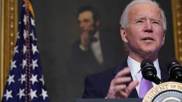 A painting of Abraham Lincoln is seen as US President Joe Biden speaks on Covid-19 response in the State Dining Room of the White House in Washington, DC on January 26, 2021. - The number of confirmed coronavirus cases around the world on January 26 passe