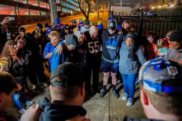 Seguidores de la NFL rezan fuera del Centro Médico de la Universidad de Cincinnati después de que Damar Hamlin, defensa de los Buffalo Bills, colapsara en el campo durante el enfrentamiento de la NFL de lunes por la noche con los Bengals en Cincinnati.