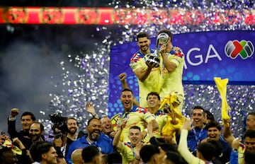 Henry Martin and Miguel Layún celebrate with the trophy after winning the Liga MX Apertura 2023.