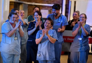 DORCHESTER, ENGLAND - APRIL 02: NHS staff from Dorset County Hospital applaud at the entrance of the Emergency Department on April 02, 2020 in Dorchester, United Kingdom. The "Clap For Our Carers" campaign has been encouraging people across the UK to take