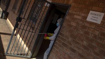 FILE - In this Thursday, May 28, 2020 file photo, a disinfection team works in a classroom at Ivory Park Secondary School east of Johannesburg, South Africa, The World Health Organization has on Thursday, Aug. 20, 2020 urged that African governments shoul