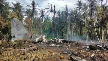 In this handout photo taken on July 4, 2021 and received from the Philippine military Joint Task Force-Sulu (JTF-Sulu), smoke billows from the wreckage of a Philippine Airforce C-130 transport plane after it crashed near the airport in Jolo town, Sulu pro