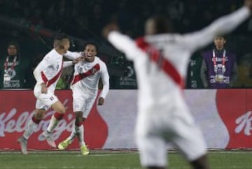 Peru's Jose Paolo Guerrero, left, celebrates with Andre Carrillo after scoring their second second goal during the soccer match against Paraguay for the third place of the Copa America at the Ester Roa Rebolledo Stadium in Concepcion, Chile, Friday, July 3, 2015. (AP Photo/Silvia Izquierdo)