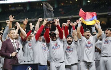 Washington Nationals players celebrate as GM Mike Rizzo and Manager Dave Martinez (R) hoist the Commissioner's Trophy after defeating the Houston Astros in the MLB 2019 World Series game seven at Minute Maid Park in Houston, Texas, USA, 30 October 2019.