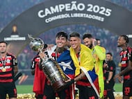Flamengo's Chilean midfielder #05 Erick Pulgar (L) and Colombian midfielder #15 Jorge Carrascal (R) pose for a photo with the trophy after winning the all Brazilian Copa Libertadores final football match between Palmeiras and Flamengo at Monumental 'U' Marathon stadium in Lima on November 29, 2025. (Photo by ERNESTO BENAVIDES / AFP)