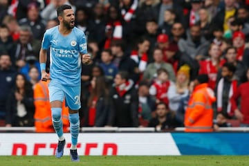 Manchester City's Algerian midfielder Riyad Mahrez celebrates after scoring the equalising goal from the penalty spot during the English Premier League football match between Arsenal and Manchester City at the Emirates Stadium in London on January 1, 2022