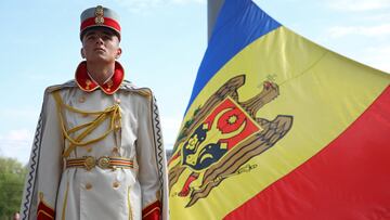 A member of the guard of honor holds the Moldovan flag during a ceremony marking the State Flag Day in Chisinau, Moldova April 27, 2022. REUTERS/Vladislav Culiomza