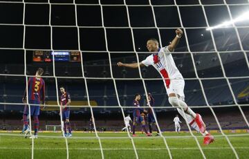 Soccer Football - Champions League - Round of 16 First Leg - FC Barcelona v Paris St Germain - Camp Nou, Barcelona, Spain - February 16, 2021 Paris St Germain's Kylian Mbappe celebrates their third goal scored by Moise Kean REUTERS/Albert Gea