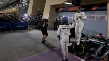 BAHRAIN, BAHRAIN - MARCH 31: Race winner Lewis Hamilton of Great Britain and Mercedes GP shakes hands with second placed Valtteri Bottas of Finland and Mercedes GP in parc ferme during the F1 Grand Prix of Bahrain at Bahrain International Circuit on March 31, 2019 in Bahrain, Bahrain. (Photo by Charles Coates/Getty Images)
