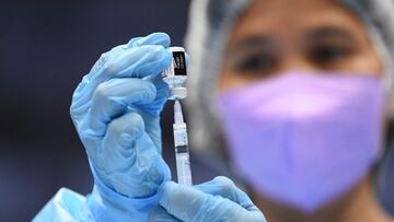 A medical worker prepares a BioNtech-Pfizer Covid-19 coronavirus vaccine at a colisium in Makati City, suburban Manila on November 29, 2021, as the Southeast Asian nation launched a three-day vaccination drive targeting nine million people as young as 12 in an effort to accelerate the roll-out of jabs, amidst the threat of heavily mutated coronavirus variant Omicron. (Photo by Ted ALJIBE / AFP)