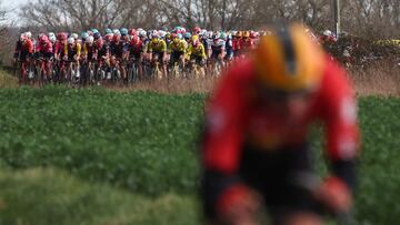 Uno-X Mobility's Norwegian rider Jonas Abrahamsen cycles in a breakaway with the pack of riders in the background during the 2nd stage of the Paris-Nice cycling race, 183,9 km between Montesson and Bellegarde, on March 10, 2025. (Photo by Anne-Christine POUJOULAT / AFP)