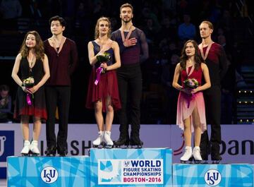 Ice Dance Gold Medalists Gabriella Papadakis and Guillaume Cizeron of France sing their national anthem as silver medalists Maia Shibutani and Alex Shibutani and bronze medalists Madison Chock and Evan Bates all from the United States look on.