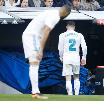Benzema (left) looks on as Carvajal heads to the dressing rooms following his red card.